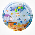 Circular inflatable water-filled cooling mat for pets with a raised outer ring and a printed underwater scene